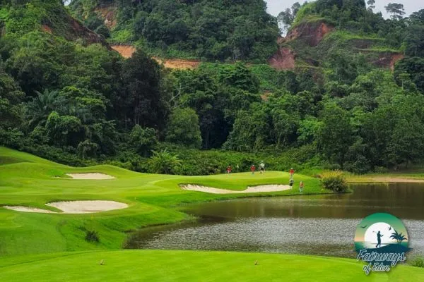 Red Mountain Golf Club Phuket – lakeside hole with bunkers and red cliffs, a top Phuket golf course for Thailand golf vacations